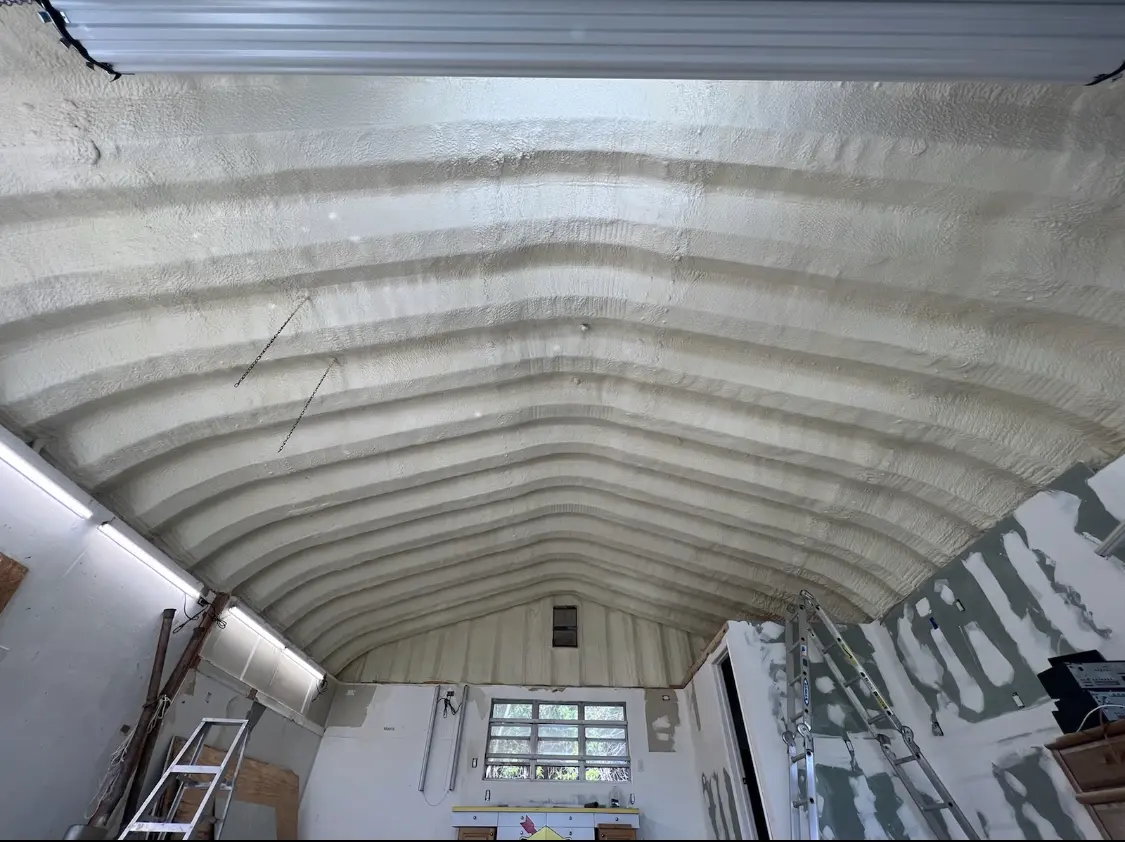 Spray polyurethane foam applied to the underside of a metal roof deck in Clark